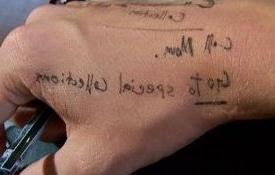 Photo of a hand with reminders written on it, including Call Mom and Go to Special Collections